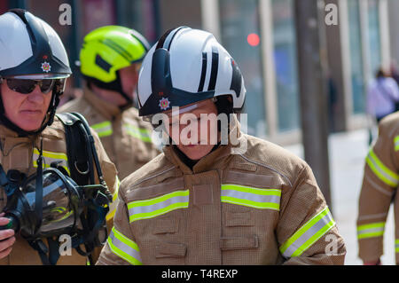 Glasgow, Scotland, UK. 18th April, 2019. Sixty trainee firefighters wearing full personal protective equipment on a sponsored march to raise funds for charity following a heritage trail through the streets of the city. The new firefighters are based at The Scottish Fire and Rescue Service National Training Centre in Cambuslang, South Lanarkshire and are eleven weeks into training. Credit: Skully/Alamy Live News Stock Photo