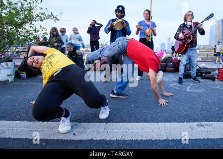 London, UK. 18th Apr, 2019. Capoeira dancers perform as the sun starts to set during 'London: International Rebellion', on day four of a protest organised by Extinction Rebellion. Protesters are demanding that governments take action against climate change. Marble Arch, Oxford Circus, Piccadilly Circus, Waterloo Bridge and Parliament Square have been blocked by activists in the last three days. Police have issued a section 14 order requiring protesters to convene at Marble Arch only so that the protest can continue. Credit: Stephen Chung/Alamy Live News Stock Photo