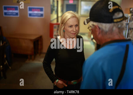 Creston, Iowa, USA. 18th Apr, 2019. New York Democratic Senator Kirsten Gillibrand campaigns for President of the United States as she speaks with a supporter during a ''listening tour'' stop at at the Adams Street Espresso & Soda Shoppe in Creston, Iowa. More than a dozen Democratic party candidates are campaigning in the state of Iowa to win the Iowa Democratic Caucuses February 3, 2020. Credit: ZUMA Press, Inc./Alamy Live News Stock Photo