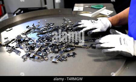 San Francisco, USA. 15th Apr, 2019. A staff checks parts of iPhone dismantled by recycling robot Daisy of Apple at a workshop in Austin, Texas, the United States, April 15, 2019. Apple said Thursday that it will quadruple the number of outlets in the United States where customers can send their iPhone to be disassembled by its recycling robot, Daisy. Credit: Wu Xiaoling/Xinhua/Alamy Live News Stock Photo