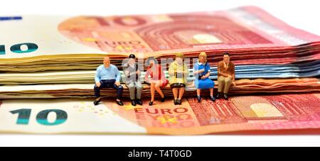 Miniature figurines, sitting on euro notes,currency, Stock Photo