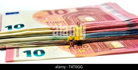Miniature figurines,single parent with child, on euro notes,currency, Stock Photo
