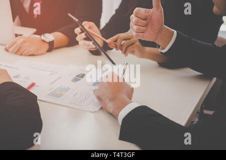 Business team is seriously discussing in meeting, no face Stock Photo