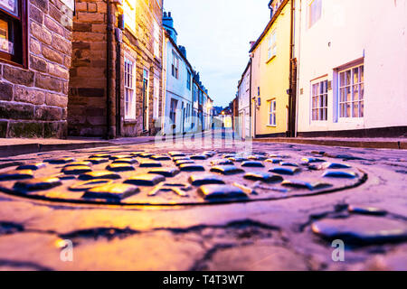 Manhole cover, drain cover, storm drain, metal drain cover, manhole, cover, covers, storm drain cover, drain, Whitby, Yorkshire, UK, England Stock Photo