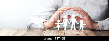 Protecting Hands Over Paper Family / Family Protection And Care Concept Stock Photo