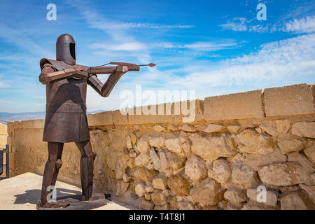 steel sculpture of medieval archer against blue sky above Santa Barbara Castle, Alicante spain Stock Photo