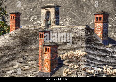 Stone roof with chimney and bell in Switzerland Stock Photo