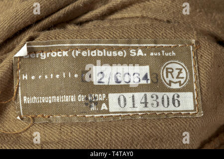 A mountain jacket for members of SA military training defense groups depot piece with RZM tag Brown woollen cloth with silver RZM buttons, brown cotton liner with superimposed inner pockets within which is an RZM tag 'Bergrock (Feldbluse) SA. aus Tuch'. Size stamping '50'. Collar tabs of base cloth with white cord edging, sewn-in shoulder boards with the silver-grey piping for army training. A rare coat. historic, historical, 20th century, Editorial-Use-Only Stock Photo