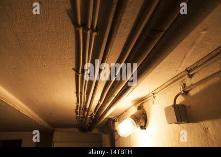 Power lines on basement ceiling Stock Photo - Alamy