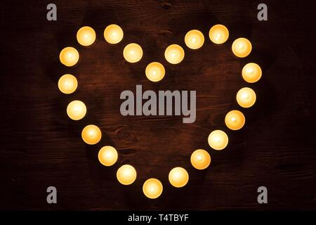 Heart-shaped established candles, burning Stock Photo