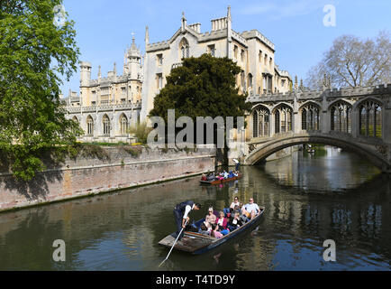 People take a punt ride under the Bridge of Sighs at St John's College in Cambridge, as parts of the UK will be hotter than some of Europe's top holiday destinations over the Easter weekend, with temperatures exceeding 20C (68F). Stock Photo