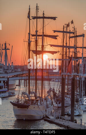 sunset behind sailing ships in Niederhafen port of Hamburg