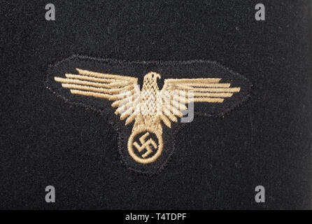 A field tunic to the black special uniform for an SS Unterscharführer in the SS armoured units, Depot piece made of black woollen cloth with large horn button and small synthetic resin buttons. SS cut with straight button fly and one-piece back. Order loops, Eastern Front Medal as buttonhole ribbon. Black cotton lining with light-coloured size stamp. Black collar patches, the right one with runes in RZM embroidery. Black slip-on shoulder boards with pink piping and silver braiding. Machine-embroidered sleeve eagle on black ground. Rare field tunic. 20th century, 1930s, 1940, Editorial-Use-Only Stock Photo