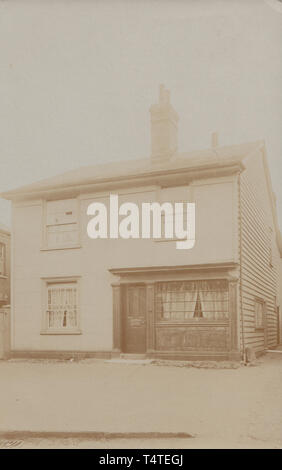 Vintage Photographic Postcard Showing an Historic Detached British Home. Possibly a Former Shop. Stock Photo