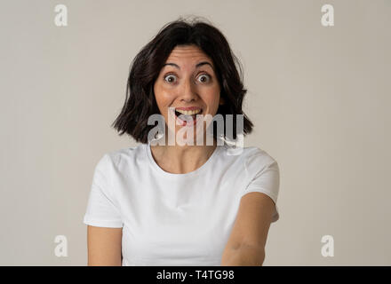 Portrait of beautiful shocked woman hearing good news or having great success with surprised and happy face. Facial Expression, Human Emotions and cel Stock Photo