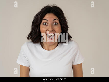 Portrait of beautiful shocked woman hearing good news or having great success with surprised and happy face. Facial Expression, Human Emotions and cel Stock Photo