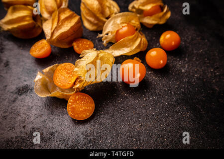 Yellow physalis fruits on black background Stock Photo