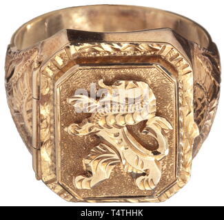 A golden finger ring of Reinhard Heydrich. The gold ring opening on a hinge and punched '585', the inner surface engraved 'R. Heydrich' and '692'. The upper surface has a figure of a lion and a continuous decorative band, laterally chased flower tendrils. Weight 14.52 g. According to the consignor, the ring comes from the personal possessions of the Heydrich family. R. Heydrich (1904 - 1942) was head of the Reich Security Office (RSHA) and conducted the so-called 'Wannsee Conference' in 1942. A short time later he was assassinated in Prague. 1 historic, historical, 20th cen, Editorial-Use-Only Stock Photo