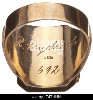 A golden finger ring of Reinhard Heydrich. The gold ring opening on a hinge and punched '585', the inner surface engraved 'R. Heydrich' and '692'. The upper surface has a figure of a lion and a continuous decorative band, laterally chased flower tendrils. Weight 14.52 g. According to the consignor, the ring comes from the personal possessions of the Heydrich family. R. Heydrich (1904 - 1942) was head of the Reich Security Office (RSHA) and conducted the so-called 'Wannsee Conference' in 1942. A short time later he was assassinated in Prague. 1 historic, historical, 20th cen, Editorial-Use-Only Stock Photo