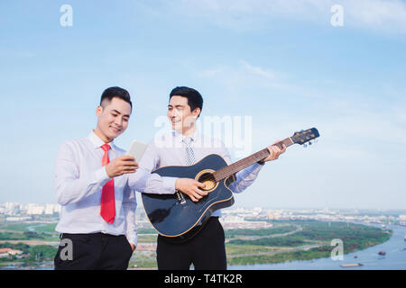 Musical Concept. Casual man playing practicing guitar. Stock Photo