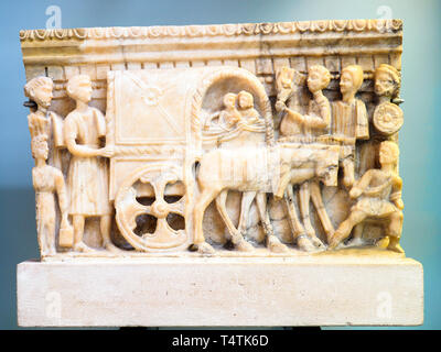 Front panel from an alabaster cinerary urn with a carved scene Etruscan, 100-50 BC Probably from Volterra Accompained by attendants, a couple is shown riding in a covered wagon (carpetum) on their journey into the underworld. Stock Photo