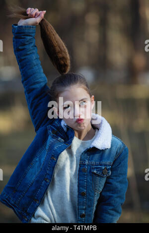 Cute twelve year old girl fooling around and posing for the camera