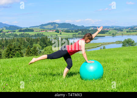 Woman doing pilates gymnastics with ball Stock Photo