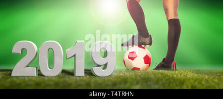 Women football, 2019. A soccer ball on the grass, female legs and number 2019. 3d illustration Stock Photo