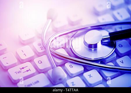 Stethoscope on computer keyboard Stock Photo