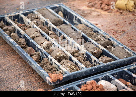 Soil samples in plastic core box. Soil boring and soil sampling for geologists study. Selective focus. Stock Photo