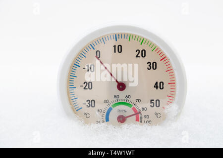 Thermometer on snow shows low temperatures in celsius. Winter time temperature measuring. Stock Photo