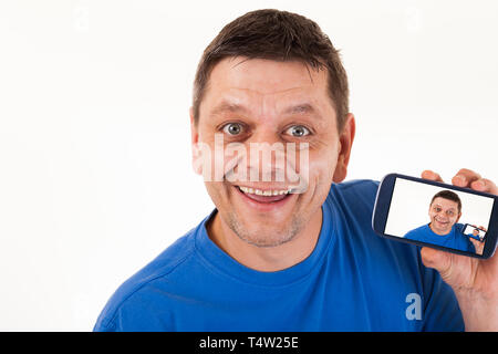 A man with repetitive self-portrait on his mobile phone. Stock Photo