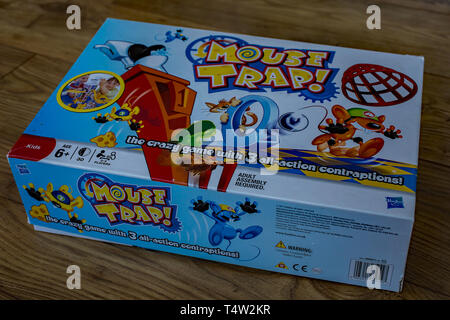Close up or Hasbro Mousetrap game all boxed up on a wooden floor ready to be played and enjoyed. Mousetrap has been around since 1962, and whilst it h Stock Photo