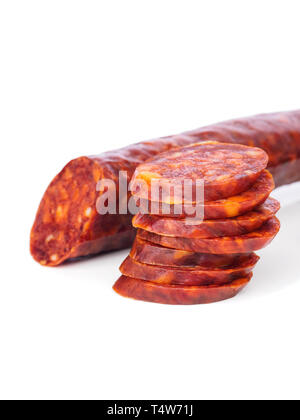 Iberian chorizo, Spanish chorizo or Spanish sausage with its slices placed one on another on a white background with its reflection, typical tapa Stock Photo