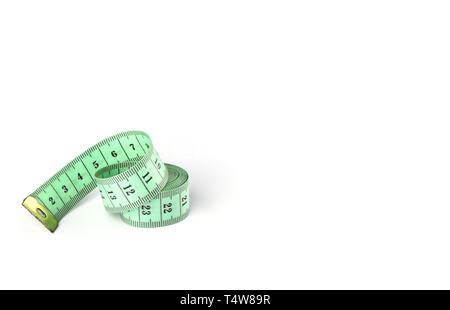 Tailoring centimeter tape twisted into a spiral isolated on a white background. Copy space Stock Photo
