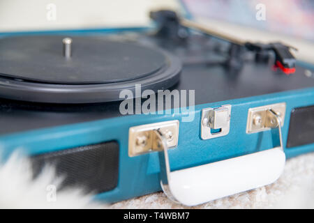 Vintage blue record player on the  carpet floor. Stock Photo