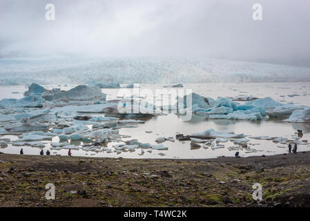 Tourists over Fjallsarlon glacier lake at the south end of the Vatnajokull glacier in southeast part of Iceland Stock Photo