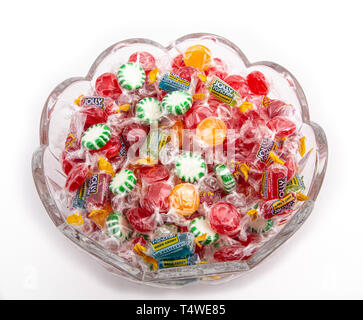 A cut glass bowl with individually wrapped hard candies Stock Photo
