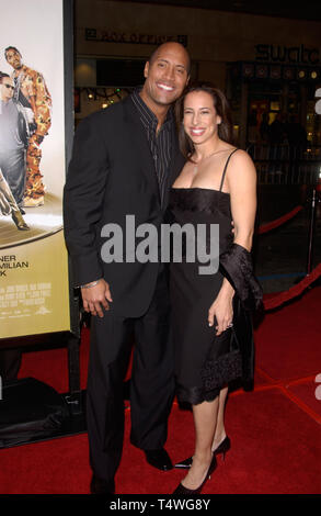 LOS ANGELES, CA. February 13, 2005:  Actor DWAYNE 'THE ROCK' JOHNSON & wife at the world premiere of his new movie Be Cool, at the Grauman's Chinese Theatre, Hollywood. Stock Photo