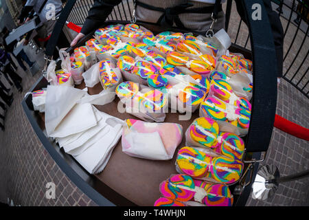 Rainbow bagels and other treats are distributed outside the New York Stock Exchange in celebration of the first day of trading for Pinterest's initial public offering (IPO) in Lower Manhattan in New York on Thursday, April 18, 2019. The social media giant priced its shares at $19 making the company worth over $10 billion, well into the 'unicorn' range.  (Â© Richard B. Levine) Stock Photo
