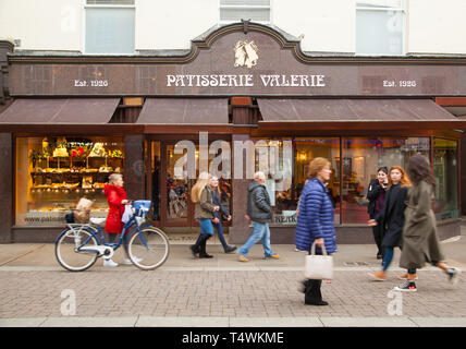 People walking past high street cafe coffee shop confectioner Patisserie Valerie Stock Photo
