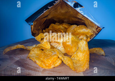 Inside the potato chips bag. Opened pack of original taste delicious potato crisps. Fast food and unhealthy eating concept Stock Photo