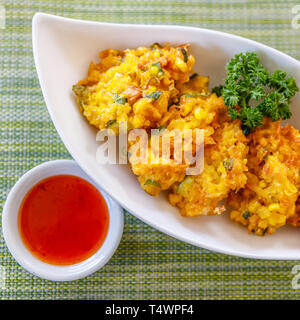 Corn fritters with Thai sweet chilly sauce. Top view. Stock Photo