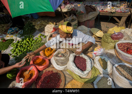 Market trader selling beans, lentils and spices in the market in Kalaw, Shan State, Myanmar. Stock Photo