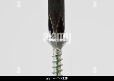 Screwdriver on screw - Concept of problem solving; finding a solution to a problem Stock Photo