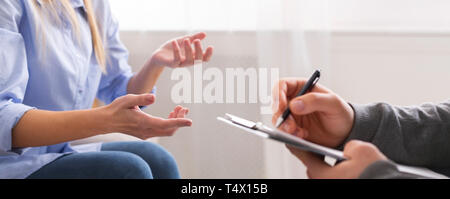 Young woman having discussion with personal therapist Stock Photo