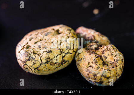 Untreated cocoa beans on black background, close-up, macro Stock Photo