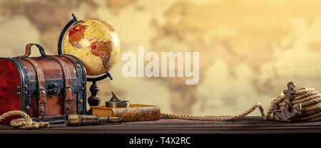 Vintage World Globe, Suitcase, Compass, Telescope, Book, Rope And Anchor With Map Background And Aged Yellowed Effect - Travel Concept Stock Photo