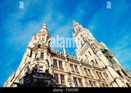Famous Rathaus Town Hall in Marienplatz on the beautiful sky background. Details. Bottom up. Munich, Germany Stock Photo