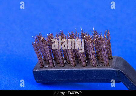 Steel brush on blue background Stock Photo